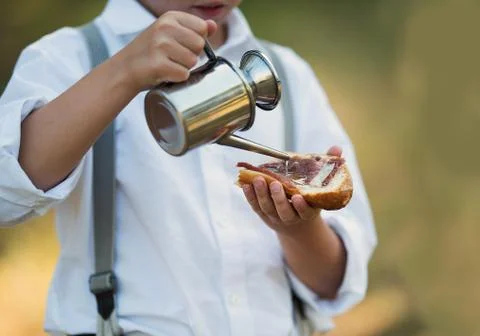 Pouring olive oil on a slice of bread on a plate Stock Photos