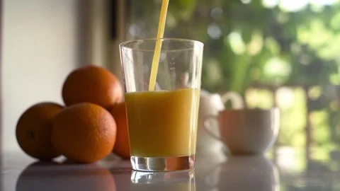 Pouring Orange Juice At The Breakfast Table Video stock 281182610