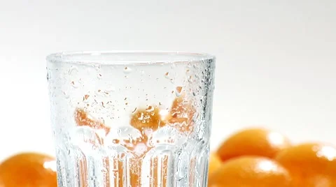 Pouring orange juice into a chilled glass (close-up) Stock Footage