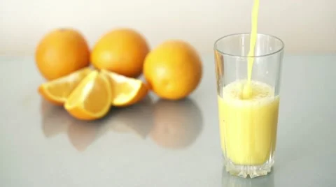 Pouring orange juice into glass, slow motion shot at 480fps HD Stock Footage