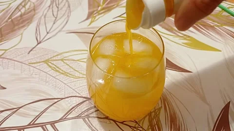 Pouring orange syrup and ice cubes, Marina di Carrara, September 10, 2026, Italy Stock Footage 345167797