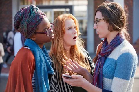 Pouring out her problems to her friends. a group of university students hanging Stock Photos