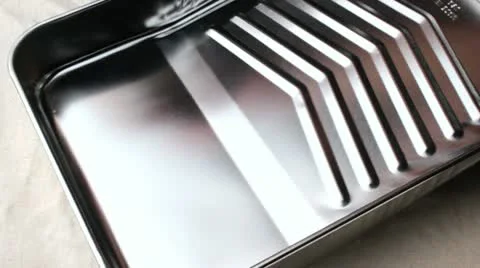 Pouring paint into paint tray Stock Footage 12733389