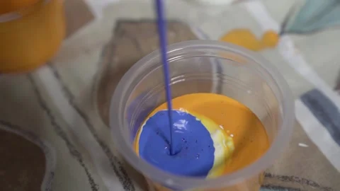 Pouring Paints into a Plastic Cup Stock-Footage 139265040