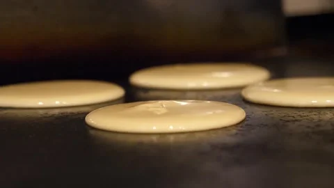 Pouring Pancake Batter on a Flat Top Commercial Griddle Stock-Footage 345291654