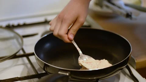 Pouring pancake batter with spoon into hot frying pan Stock Footage 340078046
