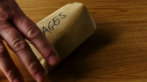 Pouring peanuts from wage packet Stock Footage 51697245