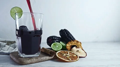 Pouring Peruvian Chicha Morada into a glass Stock Footage 342993494