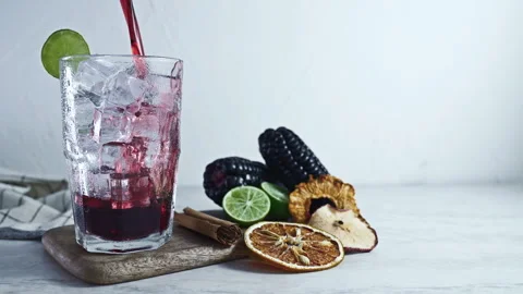 Pouring Peruvian Chicha Morada into a glass Video stock 342993498