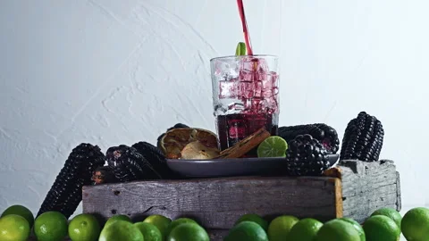 Pouring Peruvian Chicha Morada Purple Corn Drink with Lime and Cinnamon Stock Footage 335893733