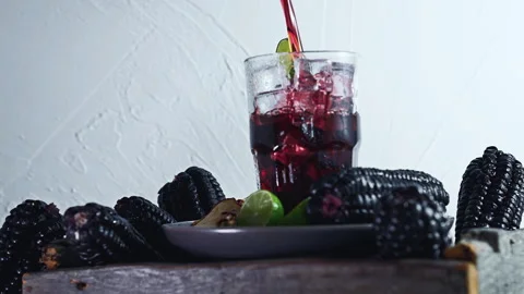 Pouring Peruvian Chicha Morada Purple Corn Drink with Lime and Cinnamon Stock Footage 335893760