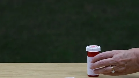 Pouring pills from a bottle Stock Footage 94427710