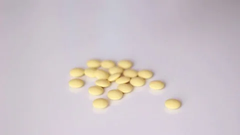Pouring pills out of the bottle on the table Stock Footage 80550001