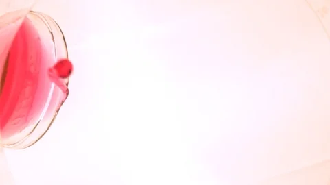 Pouring a Pink Drink with White Background Loop Boomerang Forward and Backward Stock Footage 101471552