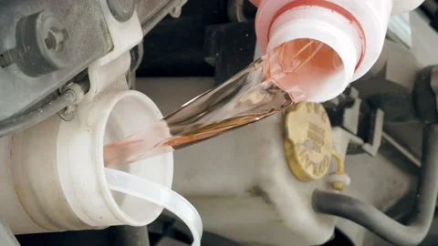 Pouring pink windshield washer fluid into the car Stock Footage 91179253