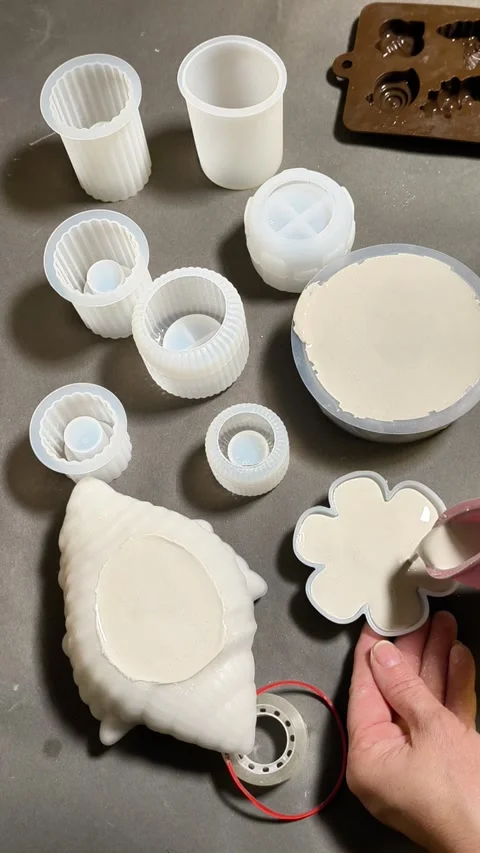 Pouring plaster mixture into silicone molds, Stock Footage 346040967