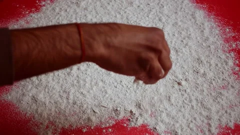 pouring powder on a red background | Stock Video | Pond5