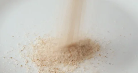 Pouring psyllium husks onto a plate Stock Footage 89756928