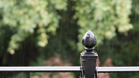 Pouring rain on black deck post Stock Footage 92921344