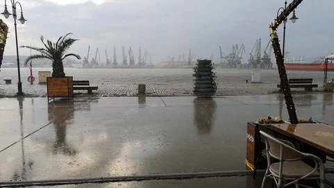 Pouring rain in open cafe on the seashore Stock Footage 107602001