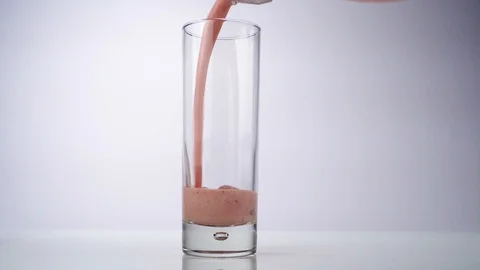 Pouring Raspberry Milkshake into a Glass Video stock 123423774
