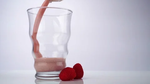 Pouring Raspberry Milkshake in a Glass Stock Footage 124914967