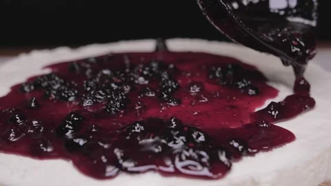 Pouring raspberry sauce on top of berry pie slow motion Stock-Footage 150457573
