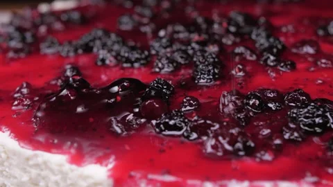 Pouring raspberry sauce on top of berry pie 4k Stock Footage 150603448