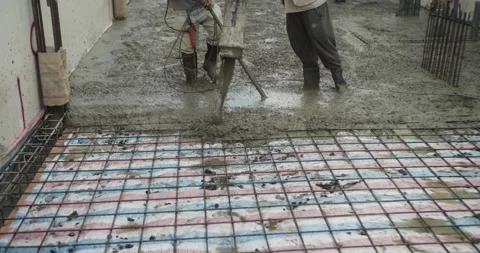 Pouring ready-mixed concrete after installing steel reinforcement to create a Stock Footage 306232014