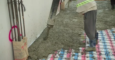 Pouring ready-mixed concrete after installing steel reinforcement to create a 動画素材 306232123