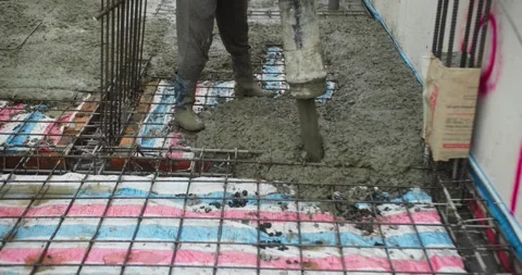 Pouring ready-mixed concrete after installing steel reinforcement to create a 動画素材 307546432