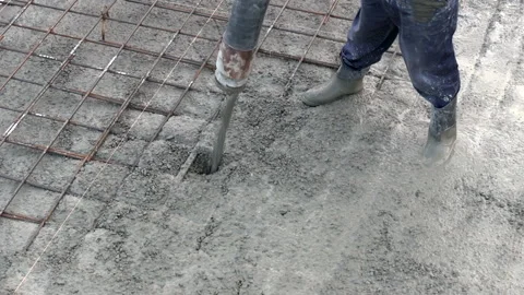 Pouring ready-mixed concrete over steel reinforcement to create house. Stock Footage 316037656