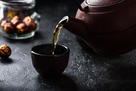 Pouring ready red tea into tea bowl Stock Photos