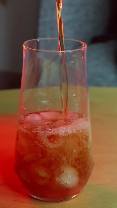 Pouring Red Beverage Over Ice Cubes Stock Footage 344548746