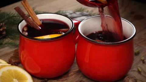 Pouring of red cup with mulled wine on festive table Stock Footage 143872229