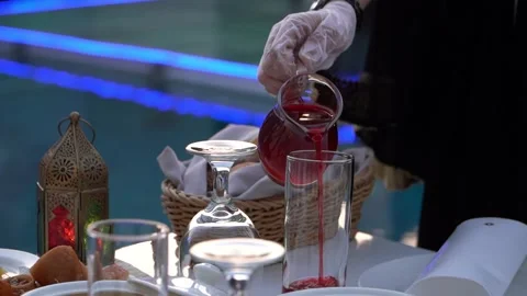 Pouring Red Drink by the Pool Stock Footage 318303112