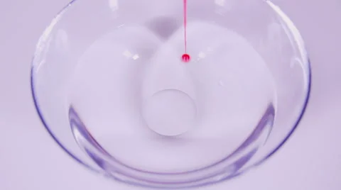 Pouring red paint into water slow motion Stock Footage 58761453