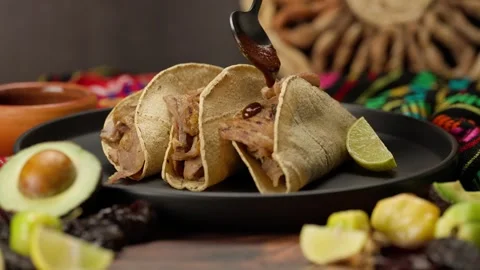 Pouring red sauce on some Mexican tacos Stock Footage 282631866