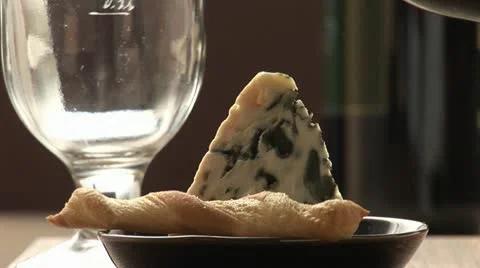Pouring red wine behind savoury straw and blue cheese Video stock 24653472