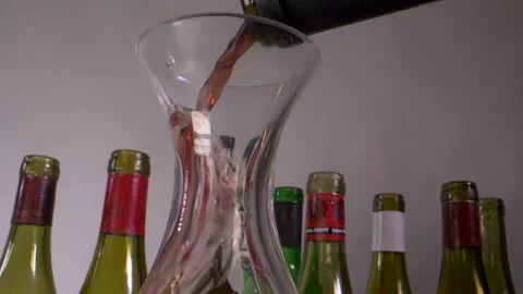 Pouring red wine into a decanter Stock Footage 132024404