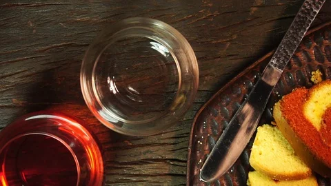 Pouring Red Wine Into A Glass with Plain Cake on Wooden Table -Slow Motion Video Stock Footage 129255877