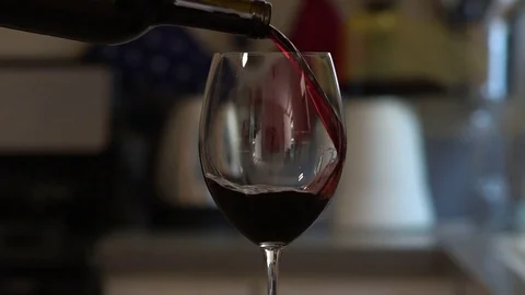 Pouring red wine into glass slowmo Stock Footage