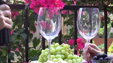 Pouring Red Wine into Glasses at Table Man and Woman Видео 78477701