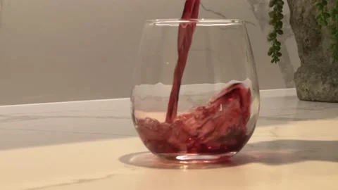 Pouring Red Wine or Red Juice into Glass Видео 196762746