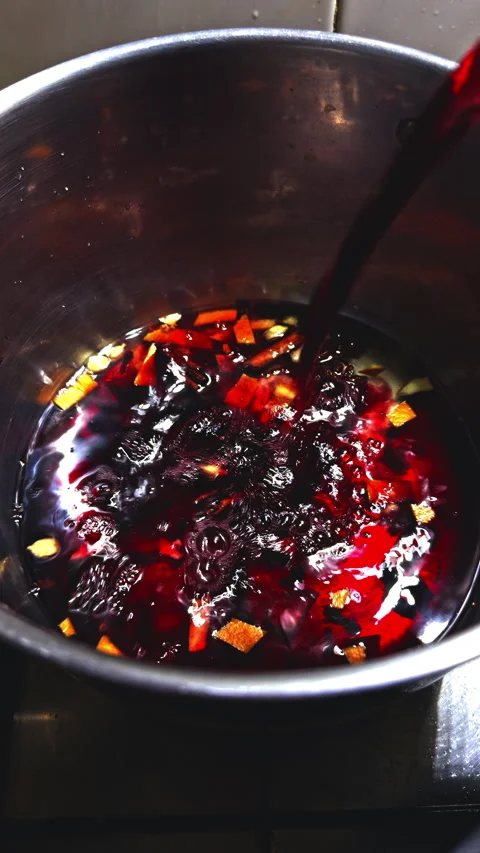 Pouring red wine with spices into pot Vídeos de archivo 338294688