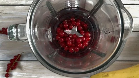 Pouring redcurrant to blender, top view Stock Footage 115340095