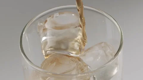 Pouring refreshing cold brew coffee over ice cubes Stock Footage 342736623