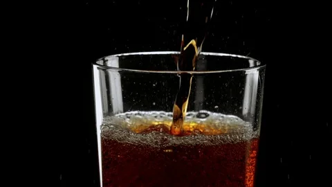 Pouring refreshing ice cold Cola in a glass Stock Footage