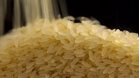 Pouring rice on a black background. Stock-Footage 195957567