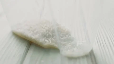 Pouring rice to food container. Kitchen organization concpet Stock Footage 305244889